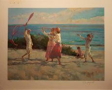 A group of five beach-goers let their kites into the wind. Nice contrast of blue sky, green shrub on the white-sand beach, and pinks of the kites and skirts.