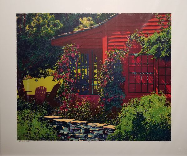 A sun-dappled bright red house with vines and hanging plants looks rather inviting.
