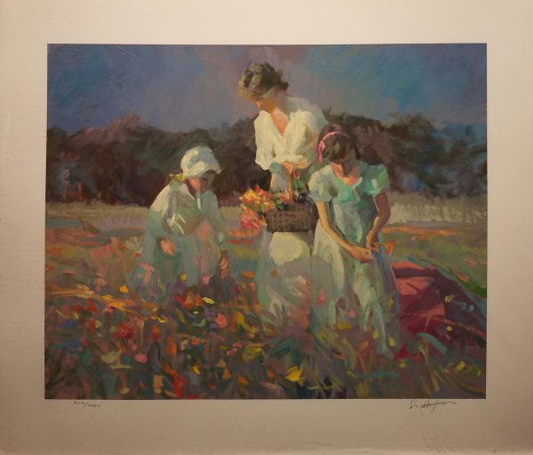 Mother collects poppies in the meadow with her two daughters.