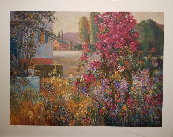 House in background on left side, explosion of colorful flowers and plants in foreground.